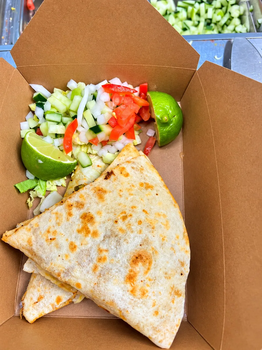 Grilled quesadilla with chopped salad and lime