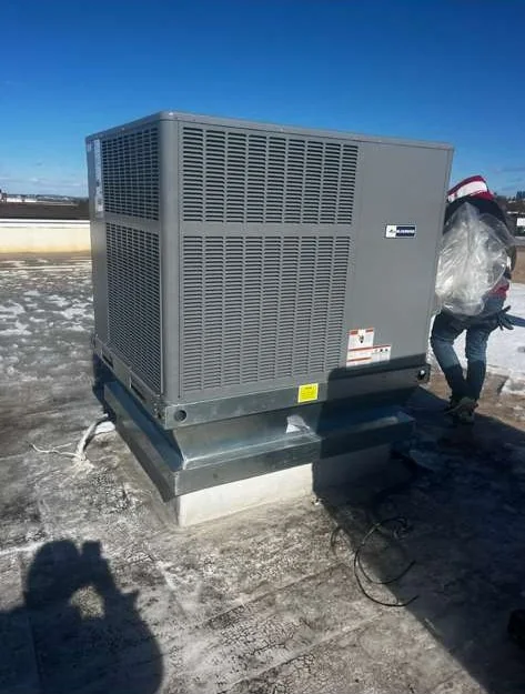 HVAC technician servicing a commercial rooftop unit